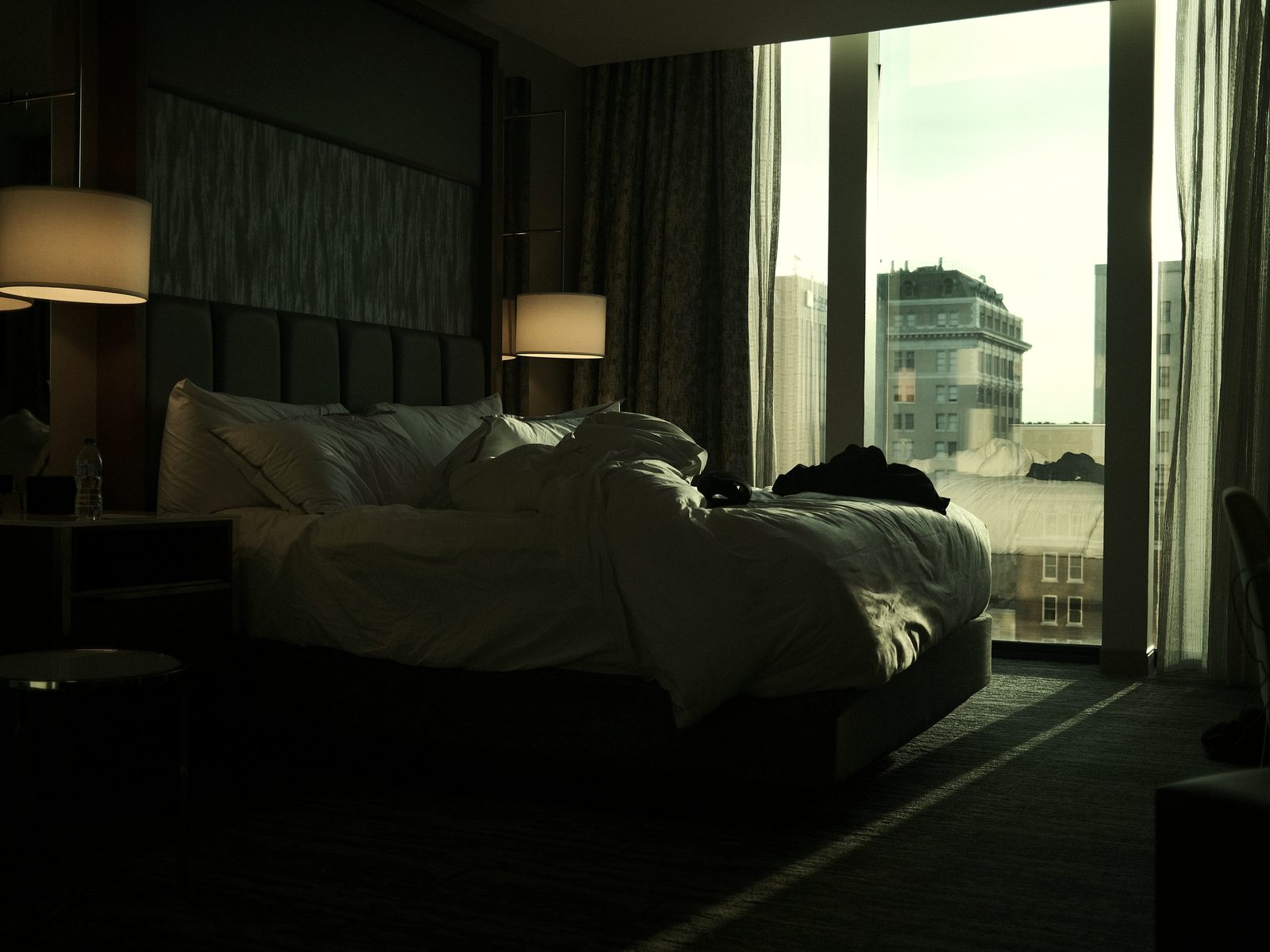 A dark hotel room at dawn